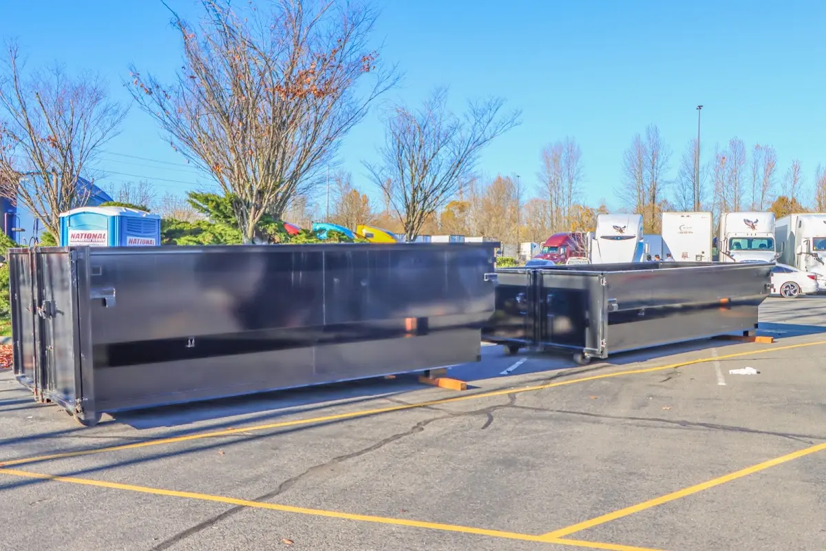 Professional dumpster rental service with roll-off container on residential driveway in Triana